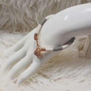 Gray & white striped faux leather charm bracelet with gold bag charm